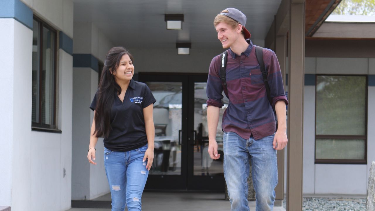 Two students exiting Hazel Burnett Hall at Omak campus