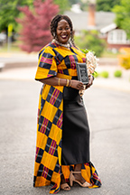 Doris "Diko" Yatta poses outside with her Capstone Impact Award